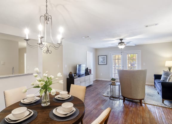 a dining room and living room with a table and chairs at Bridgewater Apartment Homes, Brandon, MS 39047