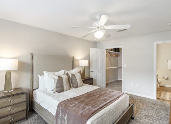a bedroom with a large bed and a ceiling fan at Bridgewater Apartment Homes, Brandon, MS 39047