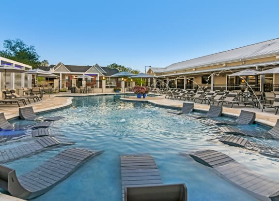 the resort style pool with lounge chairs at the resort at governors residence at Crossgates Apartment Homes, Starkville