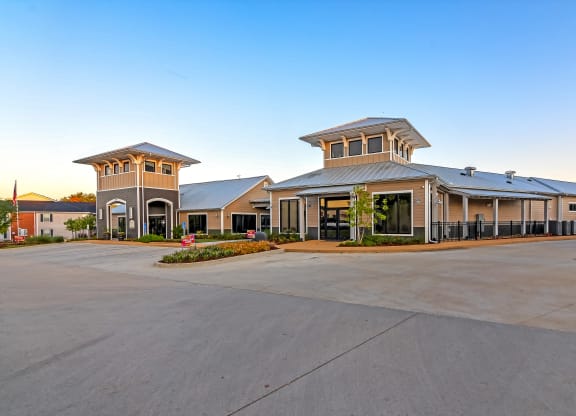 an exterior view of a building with a parking lot at Crossgates Apartment Homes, Starkville, Mississippi