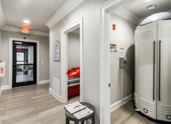 a room with two refrigerators and a door to a bedroom at Crossgates Apartment Homes, Starkville, 39759
