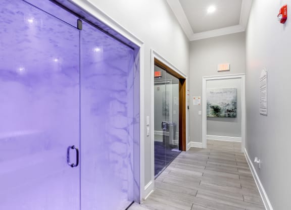 a large glass door leading to a hallway with a tile floor at Crossgates Apartment Homes, Starkville, Mississippi