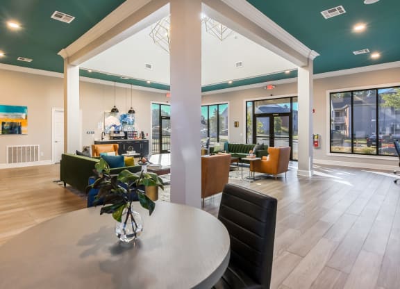 the preserve at ballantyne commons clubhouse with a round dining table and a bar at Crossgates Apartment Homes, Mississippi