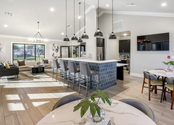 an open floor plan with a kitchen and dining area and a living room at Crossgates Apartment Homes, Starkville, MS