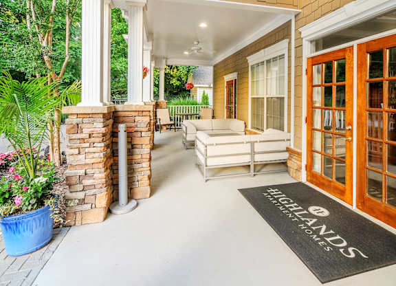 A patio area with a Highlands sign on the mat.