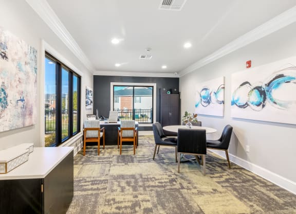 a dining room with a table and chairs and a large window at Crossgates Apartment Homes, Mississippi 39759