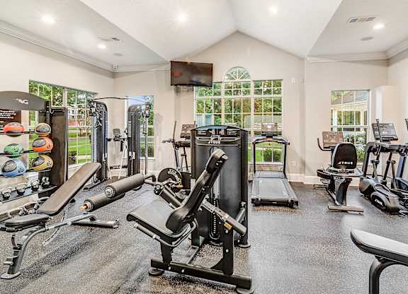 A spacious home gym with a variety of exercise equipment.