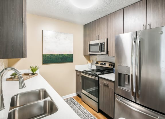 a kitchen with stainless steel appliances and a stainless steel refrigerator at Crossgates Apartment Homes, Starkville, 39759