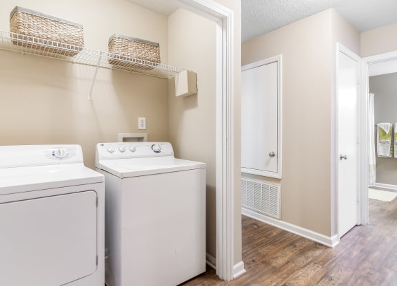 an empty laundry room with a washer and dryer and a closet at Avalon Apartments Starkville, MS