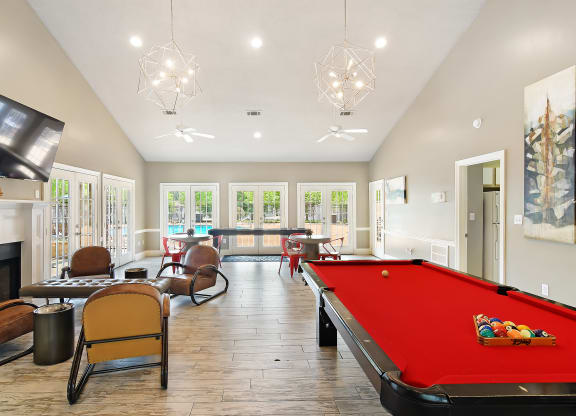 a game room with a pool table and a tv at Lexington Pointe Apartment Homes in MS 38655