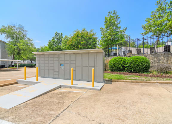a small building with yellow poles in a parking lot at Lexington Pointe Apartment Homes in Oxford, Mississippi 38655