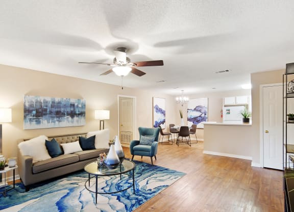 a living room with a couch and a ceiling fan at Lexington Pointe Apartment Homes in Oxford, MS 
