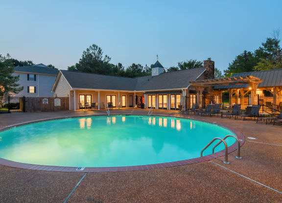 a swimming pool with a house in the background at Lexington Pointe Apartment Homes in Mississippi 38655