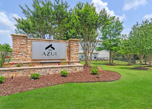 monument sign with trees and grass at The Azul Apartment Homes in Oxford, Mississippi 38655
