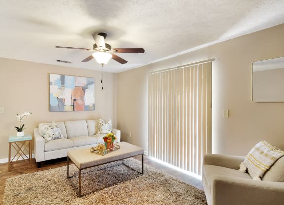 a living room with a ceiling fan and a couch at Parklane Apartment Homes, McComb, Mississippi