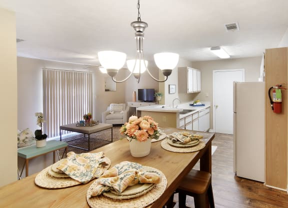 a kitchen and dining room with a table and chairs at Parklane Apartment Homes, McComb, 39648