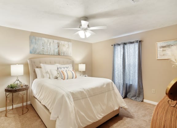 a bedroom with a large bed and a ceiling fan at Parklane Apartment Homes, Mississippi, 39648