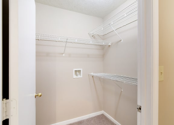 an empty closet in a home with white walls and a white door at Parklane Apartment Homes, Mississippi, 39648