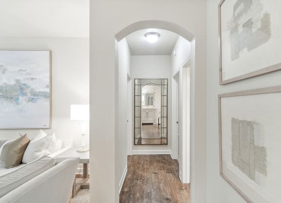 Beautiful hallway with a view of a living room and a mirrorat Faulkner Flats Apartment Homes, Oxford, Mississippi