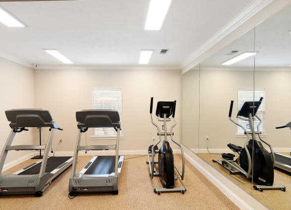 a gym with treadmills and other exercise equipment at Parklane Apartment Homes, McComb