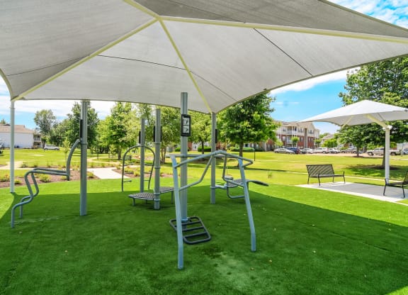 a playground at a park with swings and benches at The Vineyard of Olive Branch Apartment Homes, Olive Branch, MS, 38654