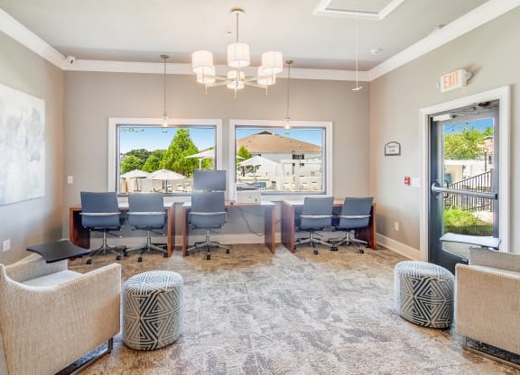 a conference room with a table and chairs and a window at The Vineyard of Olive Branch Apartment Homes, Mississippi