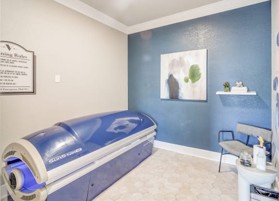 a patient room with an ultrasound bed and a table with a chair at The Vineyard of Olive Branch Apartment Homes, Olive Branch, MS