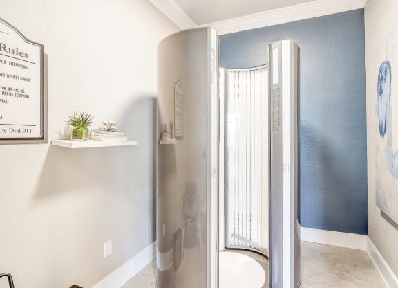 a shower in a bathroom with a blue wall and a window at The Vineyard of Olive Branch Apartment Homes, Mississippi 38654
