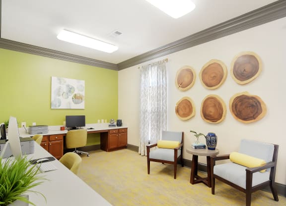 a consultation room with a desk and chairs and a table at Landing at Willow Bayou in Bossier City Louisiana