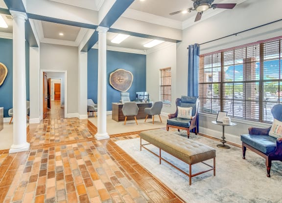 a living room with blue walls and a table with chairs at The Vineyard of Olive Branch Apartment Homes, Olive Branch