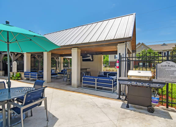 our patio with a grill and seating area at our apartments at Landing at Willow Bayou in LA 71111