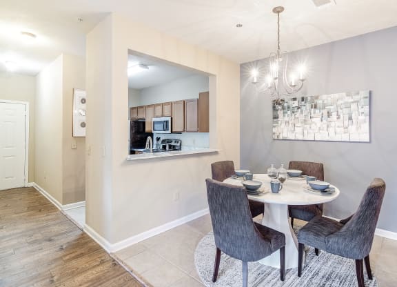 a dining area with a table and chairs and a kitchen at The Vineyard of Olive Branch Apartment Homes, Olive Branch, 38654