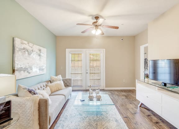 a living room with a couch and a ceiling fan at The Vineyard of Olive Branch Apartment Homes, Olive Branch, MS