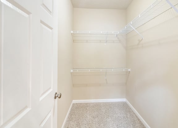 an empty closet in a home with white walls and a white door at The Vineyard of Olive Branch Apartment Homes, Olive Branch, MS