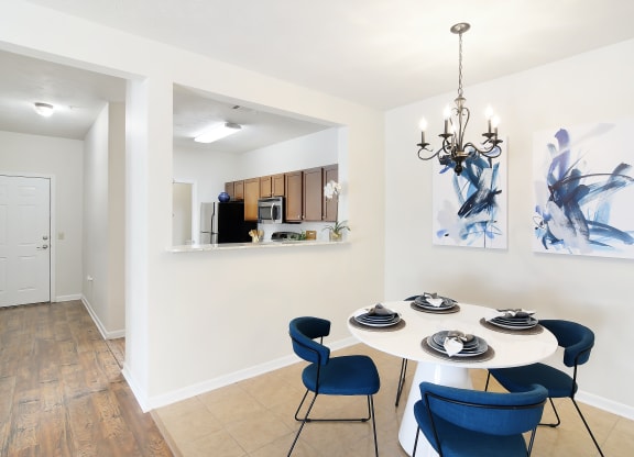 a dining room with a table and chairs and a chandelier at Landing Willow Bayou in Bossier City, LA