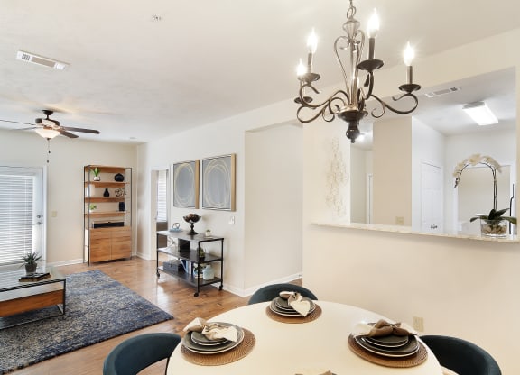 a living room with a dining room table and a chandelier at Landing at Willow Bayou in Bossier City, LA 71111