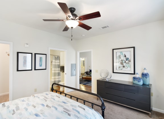 a bedroom with a bed and a ceiling fan at Landing at Willow Bayou in Bossier City, Louisiana 71111
