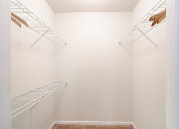 a walk in closet with white walls and shelves and two closets at Landing at Willow Bayou in Bossier City, LA 71111