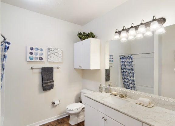 a white bathroom with a shower and a toilet and a sink at Landing at Willow Bayou in LA 71111