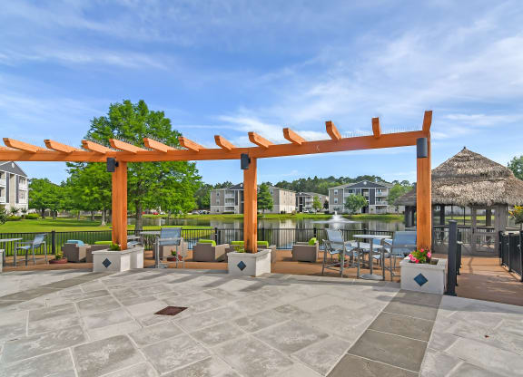 a covered patio with a gazebo and tables and chairs at Reserve at Gulf Hills Apartment Homes in Ocean Springs, 39564