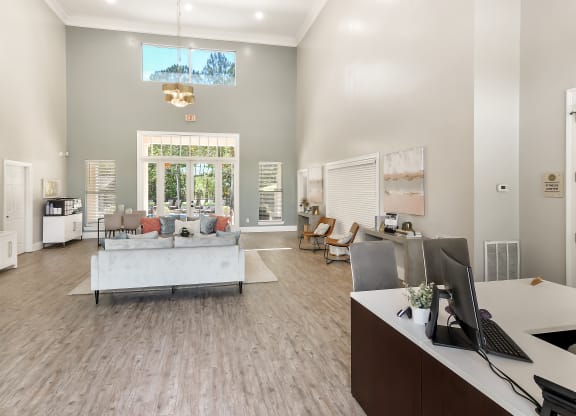 a living room with a couch and a table and a computer at Lagniappe of Biloxi Apartment Homes, Biloxi, Mississippi