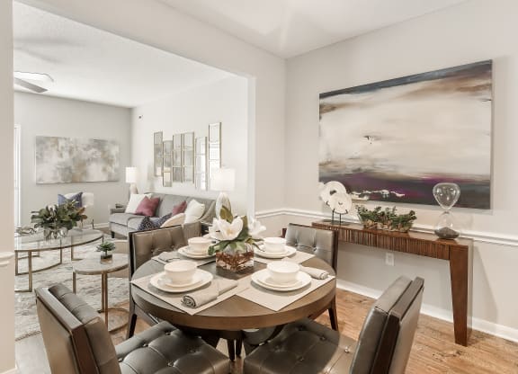 an open living room and dining room with a table and chairs at Lagniappe of Biloxi Apartment Homes, Biloxi, MS, Mississippi