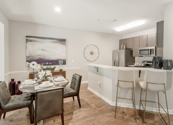 an open kitchen and dining room with a table and chairs at Lagniappe of Biloxi Apartment Homes, Biloxi, MS, Mississippi   , 39532