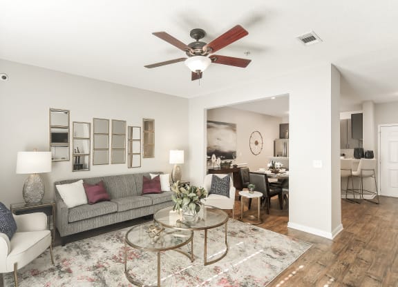 a living room with a ceiling fan and a couch at Lagniappe of Biloxi Apartment Homes, Biloxi, MS