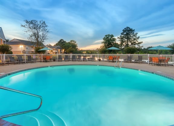 our resort style swimming pool is open to the community and has a fence around it at The Pointe Apartment Homes in Gautier, Mississippi