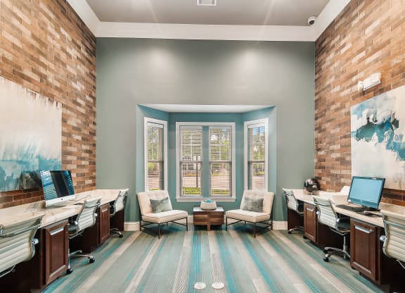 a large office with two desks and chairs and a window at Charleston Apartment Homes, Mobile, AL