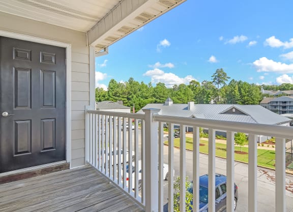 the view from the deck of a house with a black door at The Woodlands Apartment Homes, Mississippi 39301