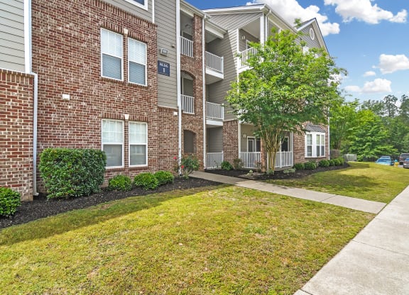 our apartments at the district feature a spacious living area and a walkway at Charleston Apartment Homes, Mobile, Alabama