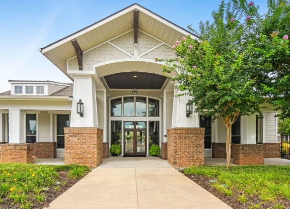 the view of the front of a building with a sidewalk and trees at Kingston Crossing Apartment Homes, Bossier City, LA, Louisiana