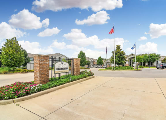 the preserve at ballantyne commons community entrance with a gate and flags at Kingston Crossing Apartment Homes, Bossier City, LA